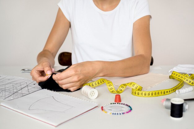 Woman sewing face mask with thread