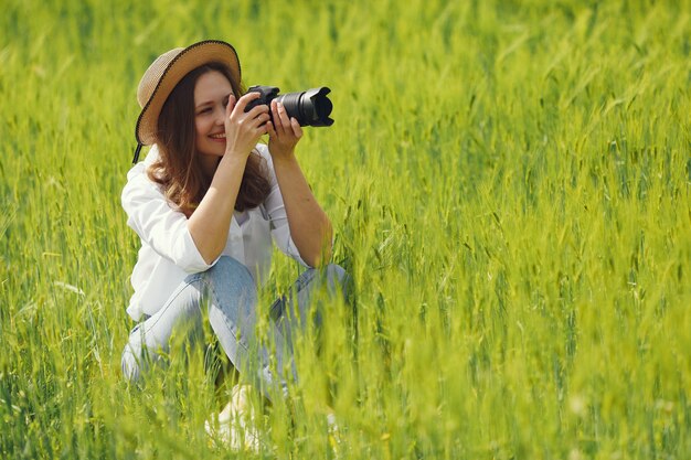 Woman shooting in a summer field