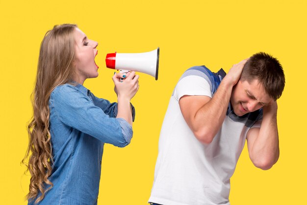 Woman shouting in megaphones at each other