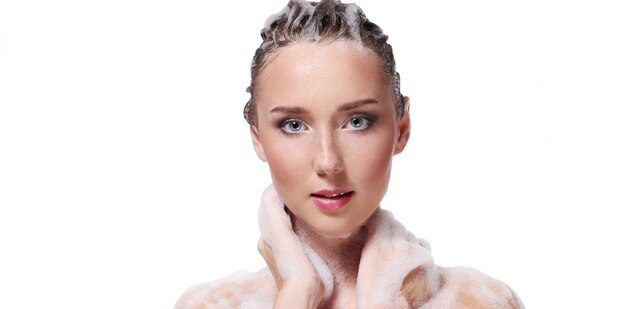 Woman showering with soap on the body and head. Hygiene and skin care concept