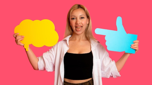 Woman showing banner looking happy excited on pink background