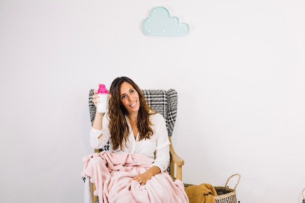 Woman showing bottle with milk