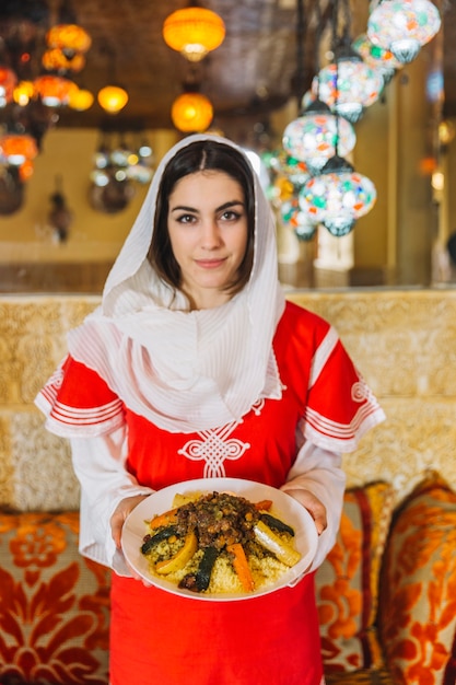 Free photo woman showing dish of arab food