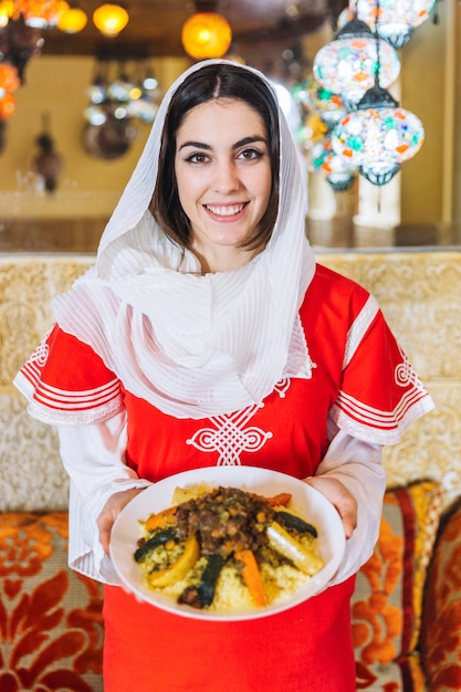 Free photo woman showing dish of arab food