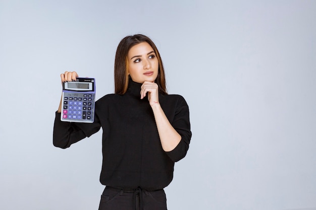 Free photo woman showing the final result on the calculator.