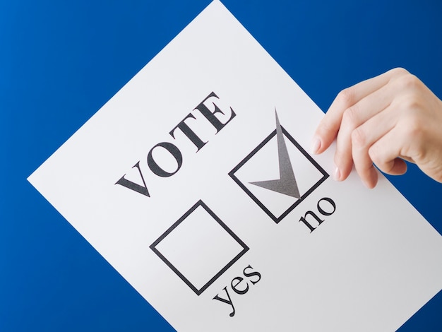 Woman showing her choice on the referendum with blue background