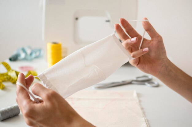 Woman showing at home sewn face mask