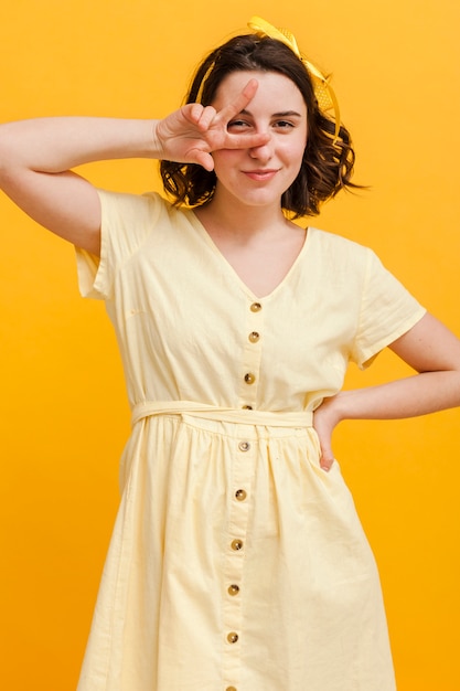 Free photo woman showing peace sign