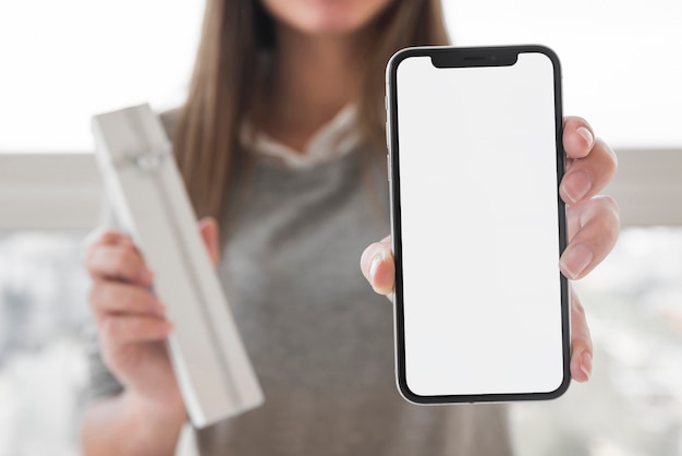 Woman showing smartphone in hand 