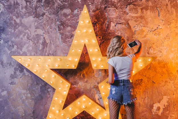 Free Photo woman showing smartphone at star