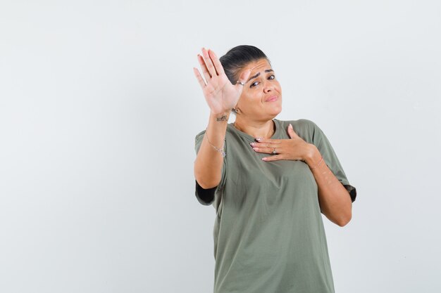 woman showing stop gesture in t-shirt and looking confident