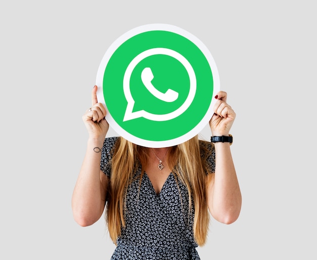 Woman showing a WhatsApp Messenger icon