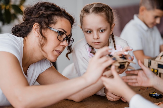 Woman showing a wooden controller to her students