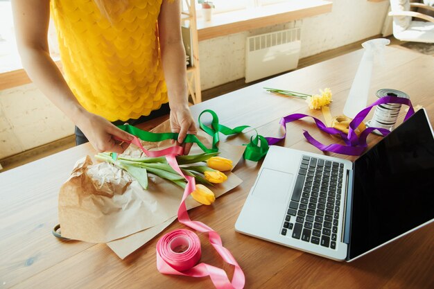 Woman shows how to make bouquet with tulips