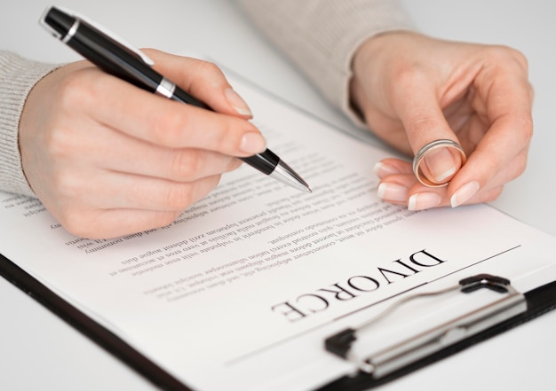 Free photo woman signing divorce document