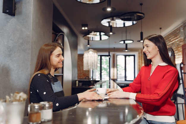 Free photo woman sitting in a cafe and talking with barista