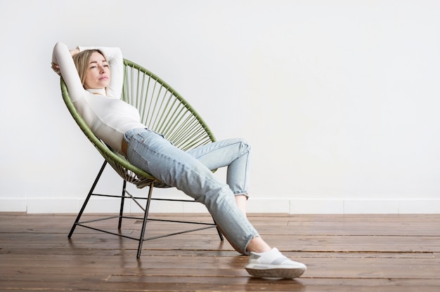 Woman sitting on a chair long shot