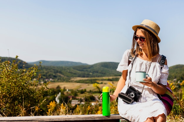 Free Photo woman sitting and enjoying a coffee