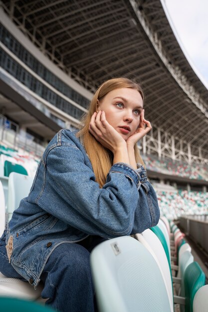 Woman sitting on grandstands side view