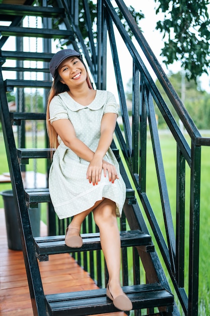 Woman sitting happily on the stairs