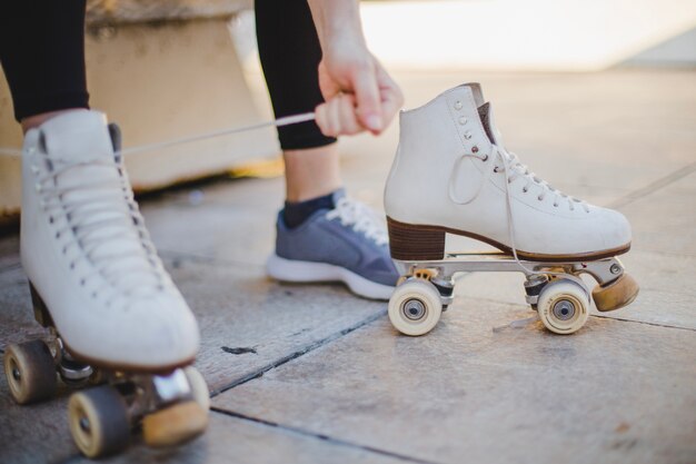 Woman sitting lacing roller skates