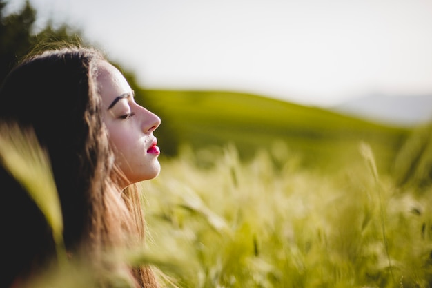 Woman sitting and meditating in grass