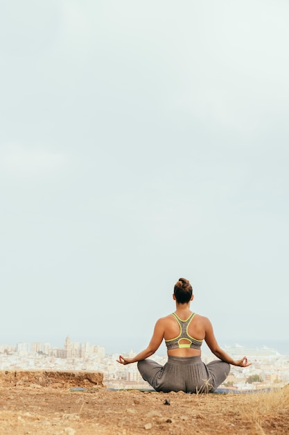 Woman sitting and meditating in the nature