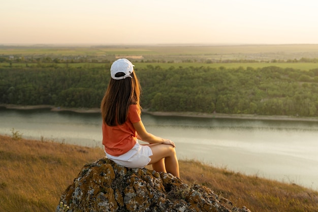 Free Photo woman sitting outdoors full shot