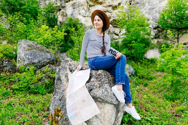 Woman sitting on rock in nature