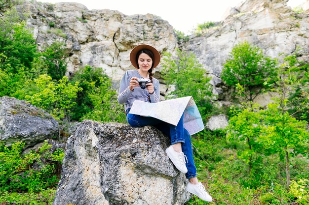 Woman sitting on rock in nature