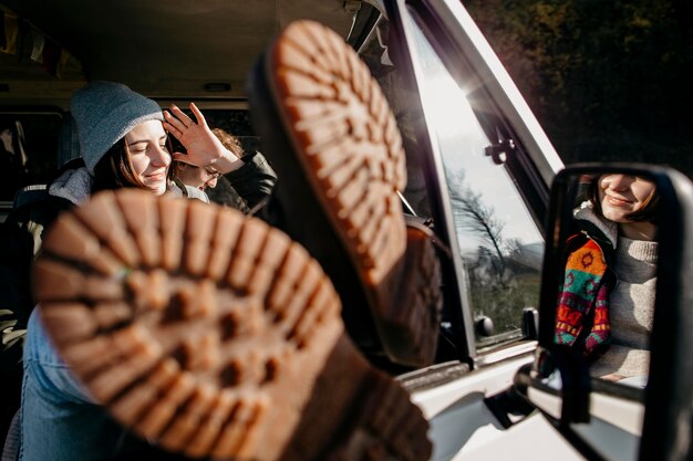 Woman sitting in a van with her legs out close up