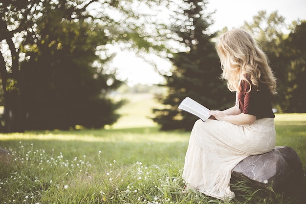 Woman sitting while reading book