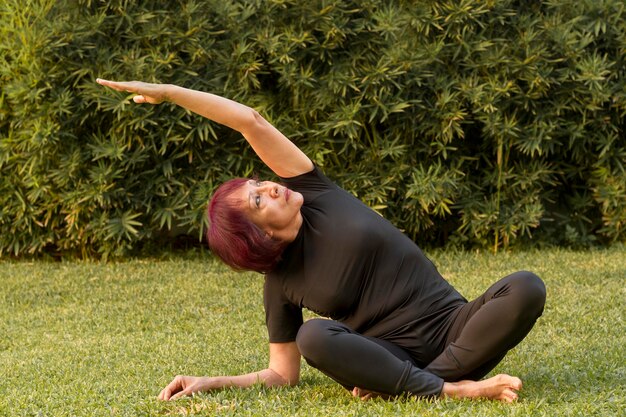 Woman sitting in yoga position and stretching