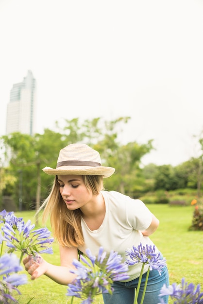 Woman smelling flowers in garden 