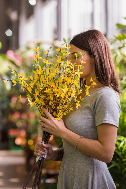 Woman smelling yellow flowers 