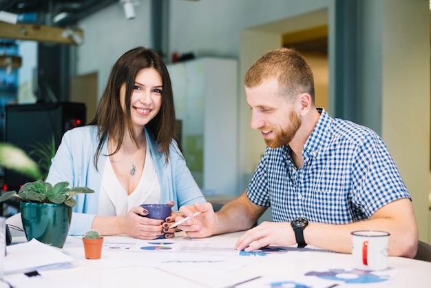 Free photo woman smiling while working with man