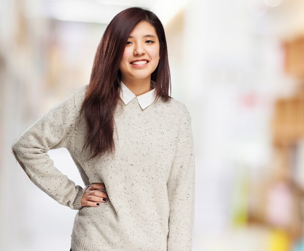 Woman smiling with one hand on hip