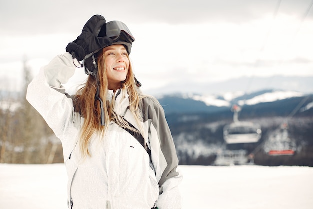 Free Photo woman in snowboard suit. sportswoman on a mountain with a snowboard in the hands on the horizon. concept on sports