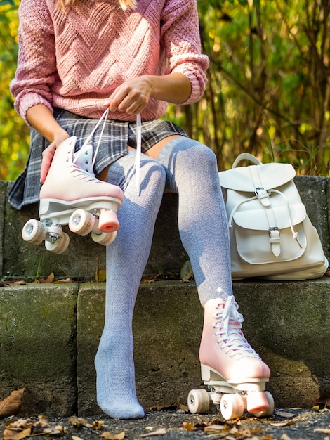 Free photo woman in socks with roller skates and backpack