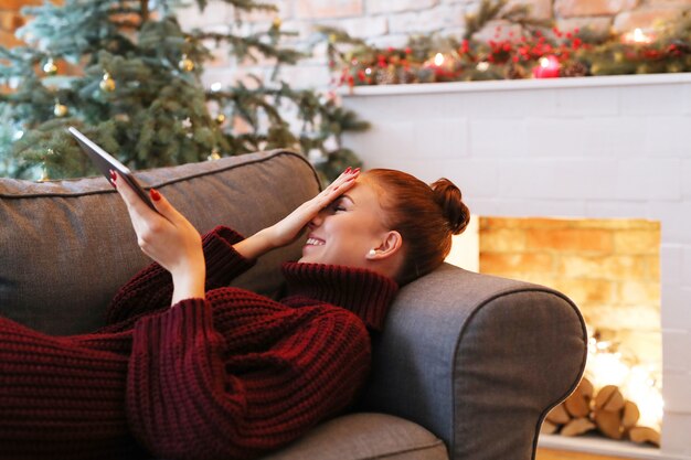 Woman on the sofa with a tablet