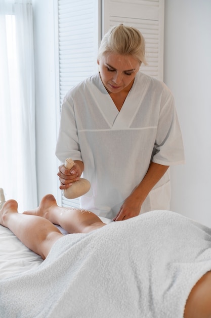 Woman spending time at the spa and getting an exfoliation massage