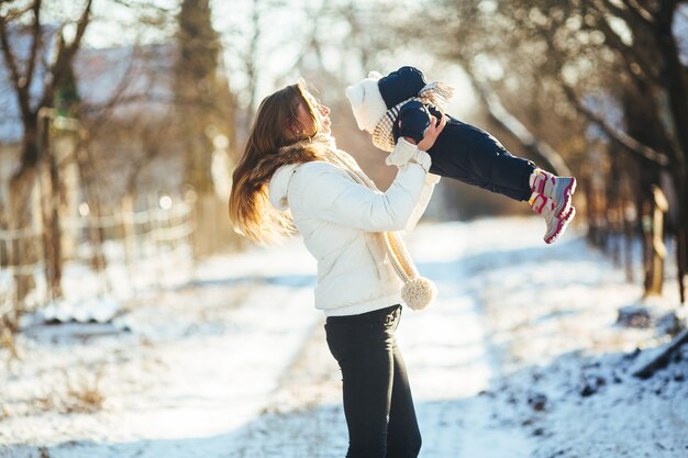 Free Photo woman spinning with her baby in hands