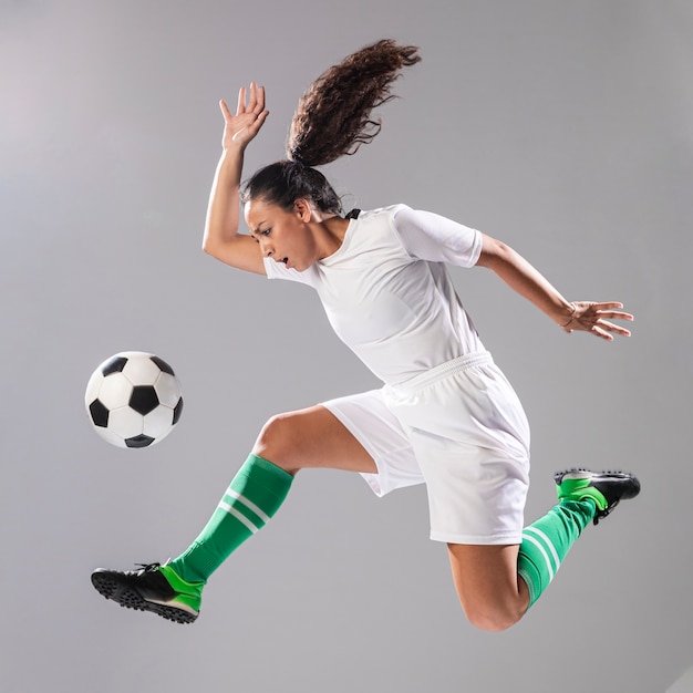 Woman in sportswear playing football