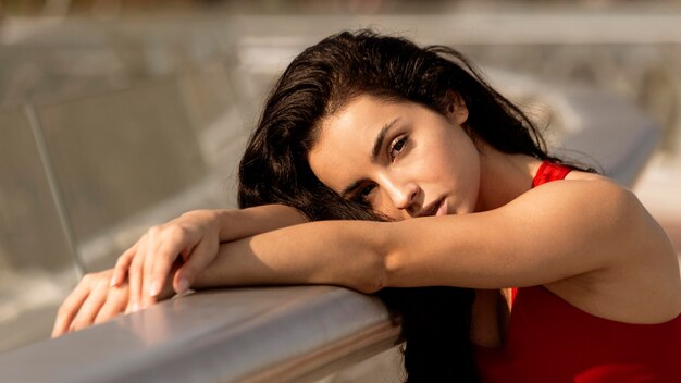 Woman in sportswear posing outdoors