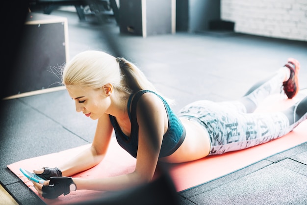 Woman in sportswear using smartphone