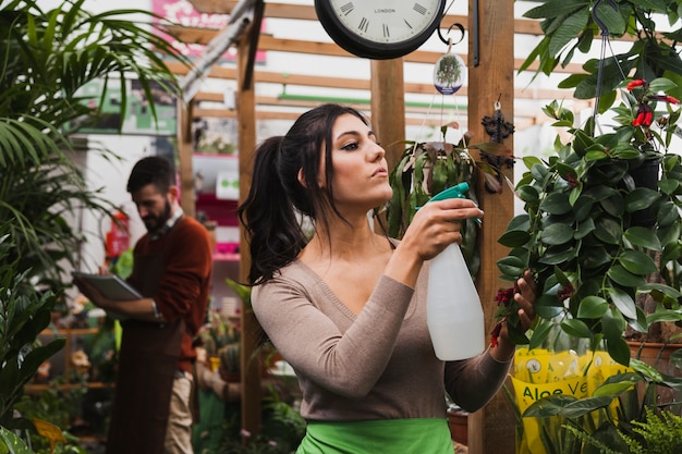 Free Photo woman spraying plants