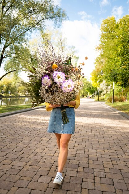 Woman in the spring holding bouquet of flowers