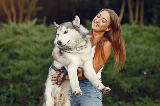 Woman in a spring park playing with cute dog