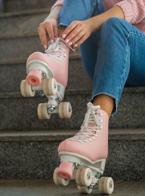 Free photo woman on stairs putting on roller skates