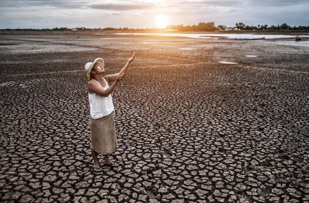 The woman stand looking at the sky and asked for rain in the dry weather, global warming